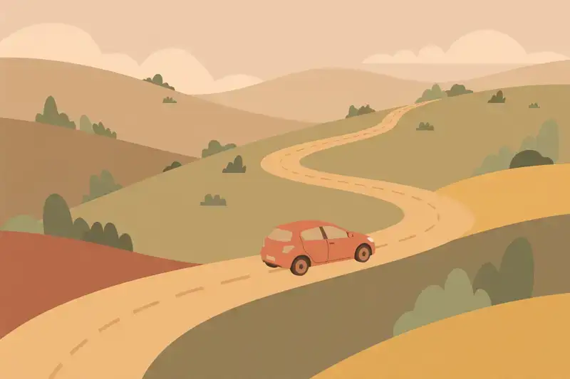A car driving on an open winding road through hills