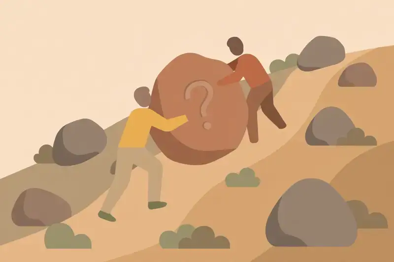 Two people pushing a boulder with a question mark up a hill